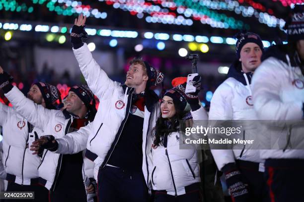 Madison Chock and Evan Bates walk with Team USA in the Parade of Athletes during the Closing Ceremony of the PyeongChang 2018 Winter Olympic Games at...