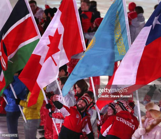 Canadian athletes parade in and congratulate Short Track Speed Skater Kim Boutin who carried in the flag for Canada during the closing ceremonies at...