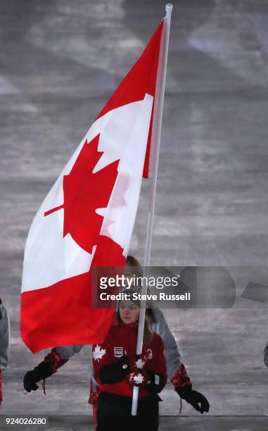 Short Track Speed Skater Kim Boutin carries in the flag for Canada during the closing ceremonies at the 2018 Pyeongchang Winter Olympics at...