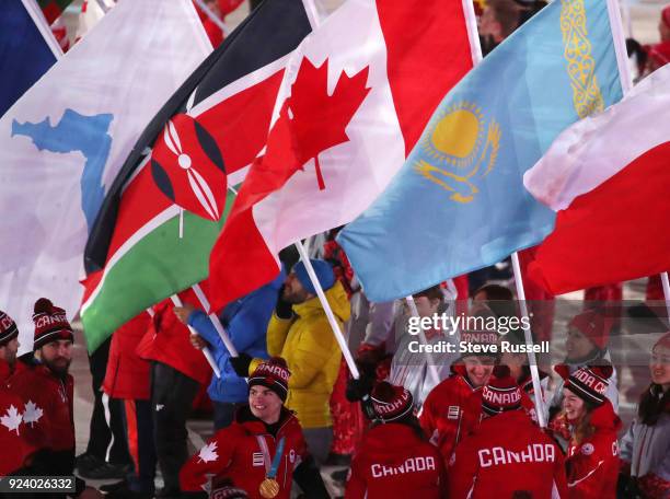 Canadian athletes parade in and congratulate Short Track Speed Skater Kim Boutin who carried in the flag for Canada during the closing ceremonies at...