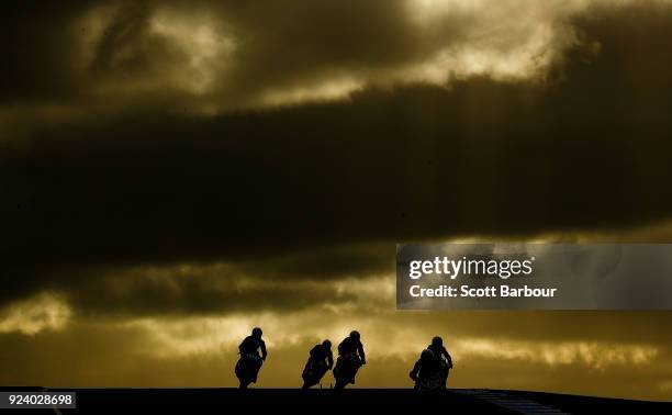 Motorcycle riders are silhouetted as they compete in the YMF R3 Cup race 3 ahead of the 2018 Superbikes at the Phillip Island Grand Prix Circuit on...