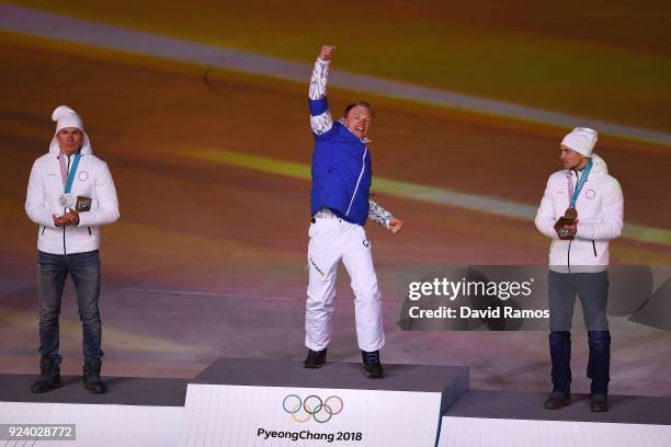 Silver medalist Aleksandr Bolshunov of Olympic Athlete from Russia, gold medalist Iivo Niskanen of Finland and bronze medalist Andrey Larkov of...