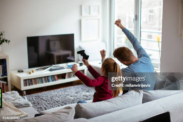 dad and daugther weekend time - family television stock pictures, royalty-free photos & images