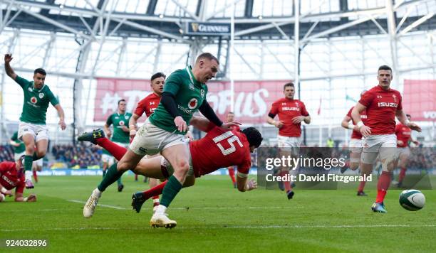 Dublin , Ireland - 24 February 2018; Keith Earls of Ireland pursues his kick forward alongside Leigh Halfpenny of Wales during the NatWest Six...