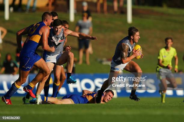 Hamish Hartlett of the Power runs with the ball during the JLT Community Series AFL match between the West Coast Eagles and the Port Adelaide Power...