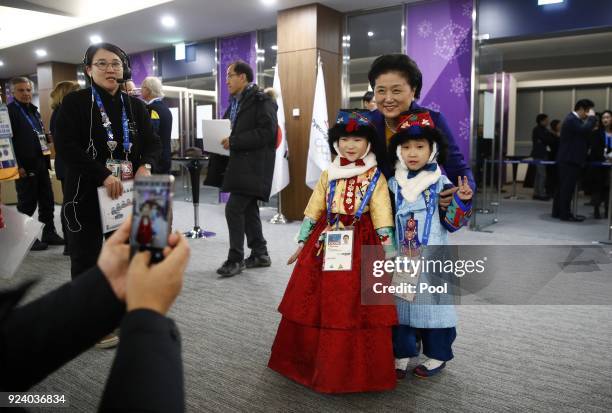 Chinese Vice Premier Liu Yandong poses for a photograph with young participants in the closing ceremony of the 2018 Winter Olympics on day sixteen of...