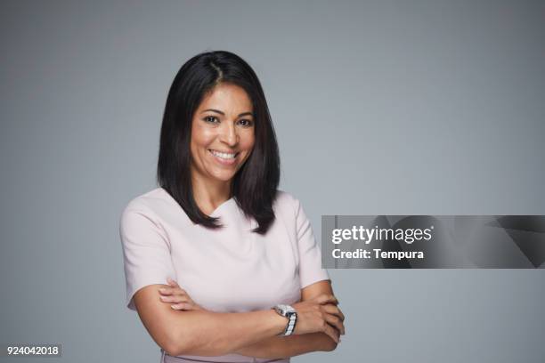 beautiful woman headshot looking at camera. - woman gray background stock pictures, royalty-free photos & images