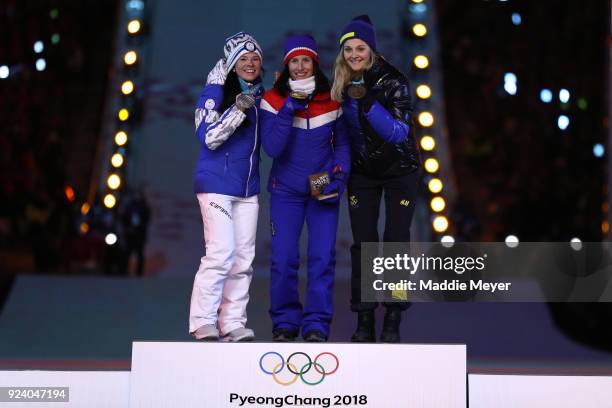 Silver medalist Krista Parmakoski of Finland, gold medalist Marit Bjorgen of Norway and bronze medalist Stina Nilsson of Sweden poses during the...