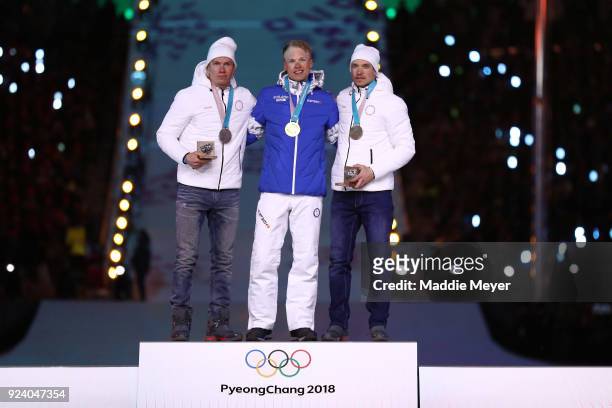 Silver medalist Aleksandr Bolshunov of Olympic Athlete from Russia, gold medalist Iivo Niskanen of Finland and bronze medalist Andrey Larkov of...