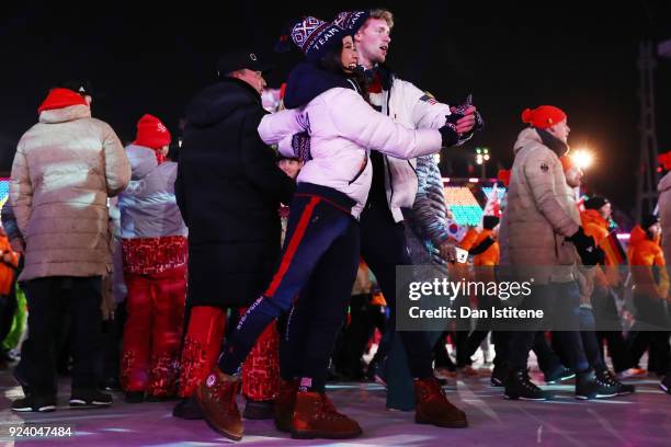 Madison Chock and Evan Bates walk with Team USA in the Parade of Athletes during the Closing Ceremony of the PyeongChang 2018 Winter Olympic Games at...