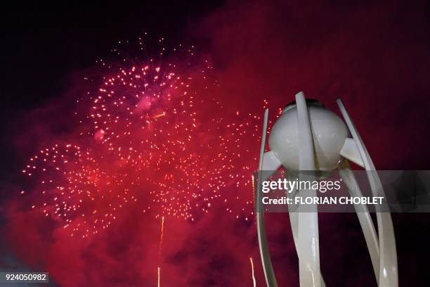 Fireworks light up the night sky outside the closing ceremony as the Olympic flame is put out at the Pyeongchang 2018 Winter Olympic Games at the...