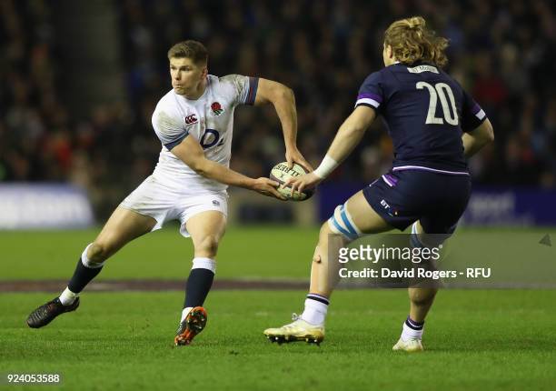 Owen Farrell of England passes the ball watched by David Denton during the NatWest Six Nations match between Scotland and England at Murrayfield on...