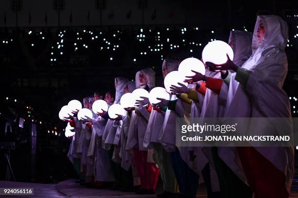 Entertainers hold lit globes during the closing ceremony of the Pyeongchang 2018 Winter Olympic Games at the Pyeongchang Stadium on February 25,...