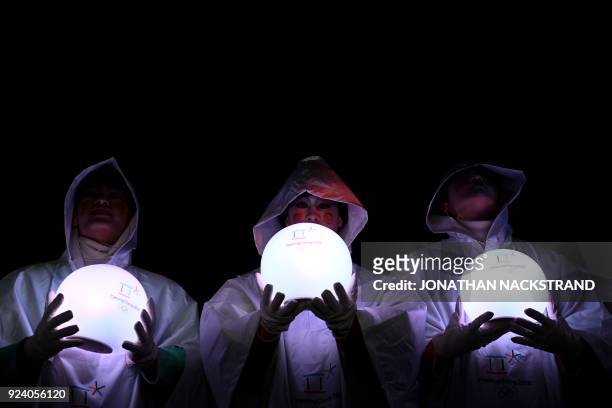 Entertainers hold lit globes during the closing ceremony of the Pyeongchang 2018 Winter Olympic Games at the Pyeongchang Stadium on February 25,...