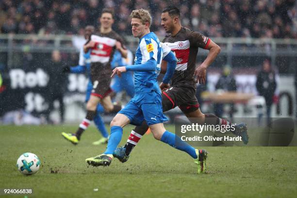 Aziz Bouhaddouz of Hamburg and Johannes van den Bergh of Kiel compete for the ball during the Second Bundesliga match between FC St. Pauli and...