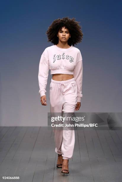 Model walks the catwalk at the Juicy Couture show during the London Fashion Week Festival February 2018 on February 25, 2018 in London, United...