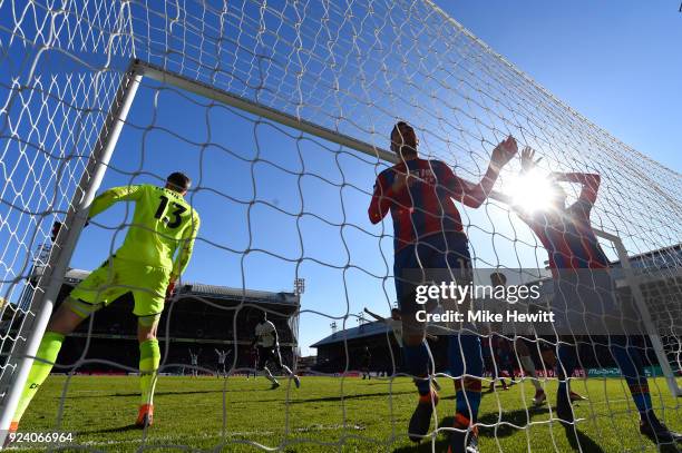 Christian Benteke and James McArthur of Crystal Palace react after Harry Kane of Tottenham Hotspur scored the first goal during the Premier League...