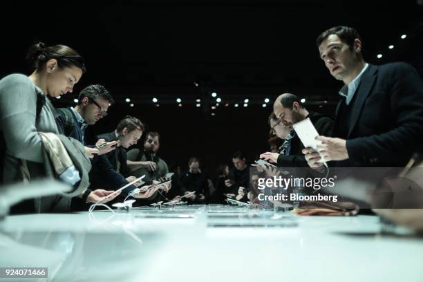 Attendees look at MediaPad tablet devices on display during a Huawei Technologies Co. Launch event ahead of the Mobile World Congress in Barcelona,...