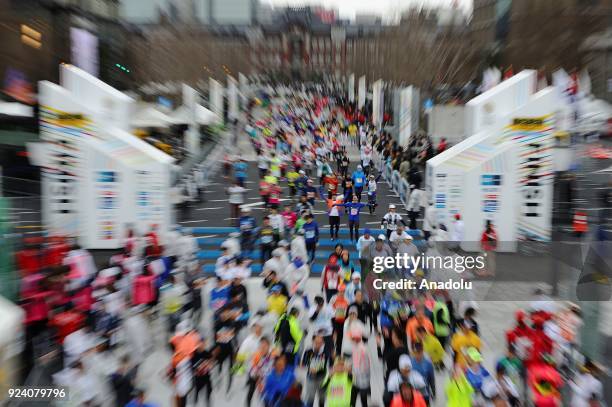 Runner reacts after crossing the finish line of the 12th Tokyo Marathon in Tokyo, Japan on February 25, 2018.