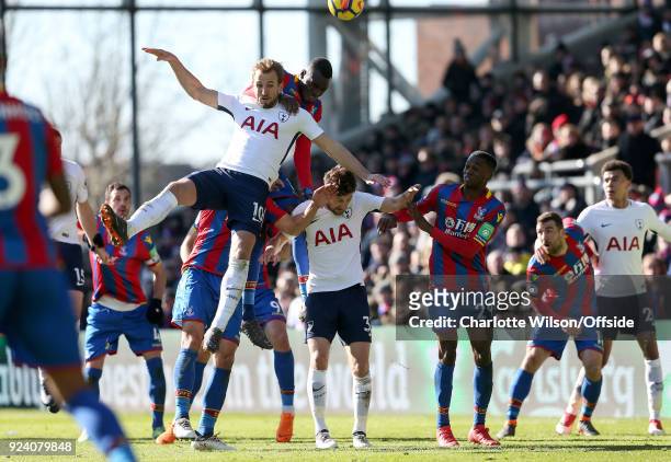 Harry Kane of Tottenham falls across Ben Davies of Tottenham and Aaron Wan-Bissaka after going up for a header with Christian Benteke of Crystal...