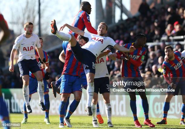 Harry Kane of Tottenham falls across James Tomkins of Crystal Palace, Ben Davies of Tottenham and Aaron Wan-Bissaka after going up for a header with...