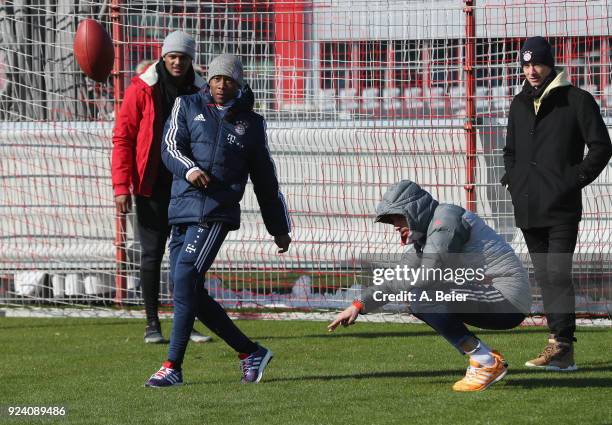 David Alaba , Robert Lewandowski and Javi Martinez of FC Bayern Muenchen perform with NFL player Deshaun Watson of Houston Texans after a training...