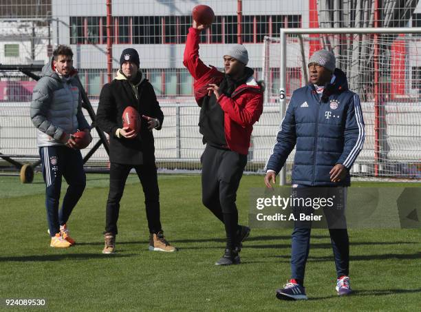 David Alaba , Robert Lewandowski and Javi Martinez of FC Bayern Muenchen perform with NFL player Deshaun Watson of Houston Texans after a training...