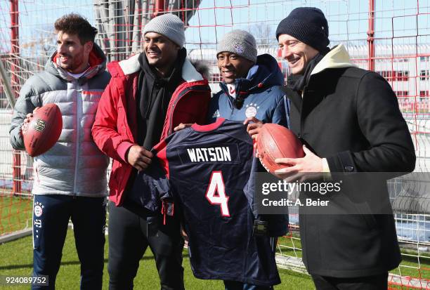 David Alaba , Robert Lewandowski and Javi Martinez of FC Bayern Muenchen pose with NFL player Deshaun Watson of Houston Texans after a training...