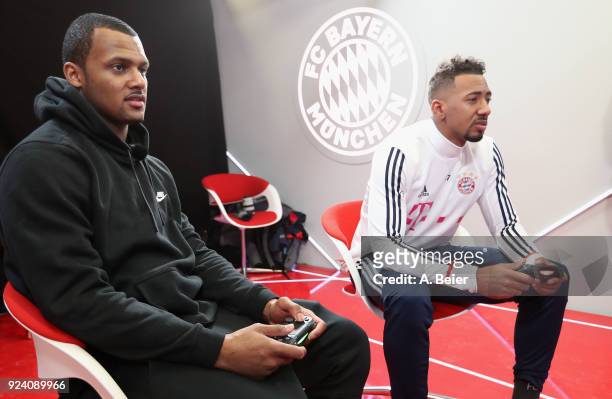 Jerome Boateng of FC Bayern Muenchen and NFL player Deshaun Watson of Houston Texans play a computer game after a training session at the club's...