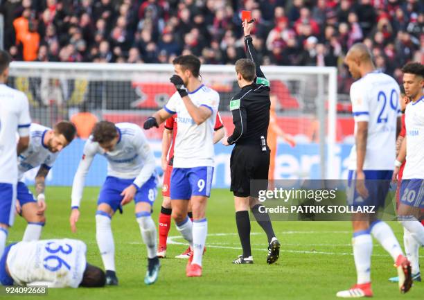 Referee Daniel Siebert shows the red card to Leverkusen's German midfielder Dominik Kohr during the German first division Bundesliga football match...