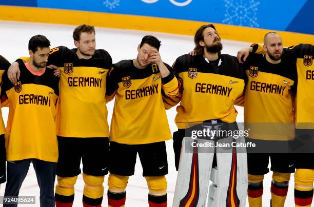 Patrick Hager of Germany and teammates look dejected after defeat following the Men's Ice Hockey Gold Medal match between Germany and Olympic...