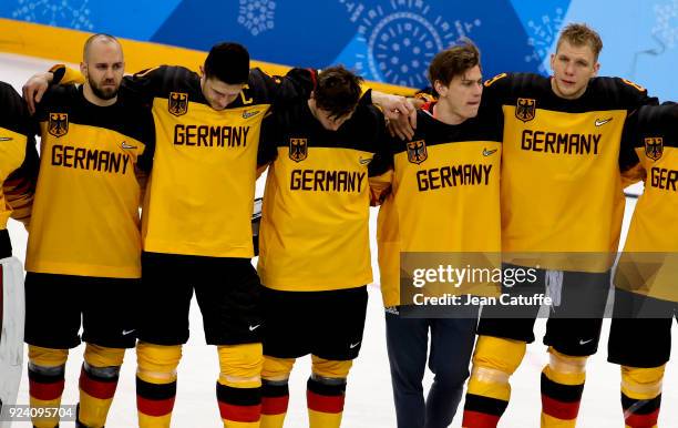 Patrick Hager of Germany and teammates look dejected after defeat following the Men's Ice Hockey Gold Medal match between Germany and Olympic...