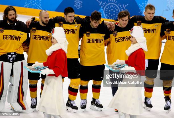 Patrick Hager of Germany and teammates look dejected after defeat following the Men's Ice Hockey Gold Medal match between Germany and Olympic...