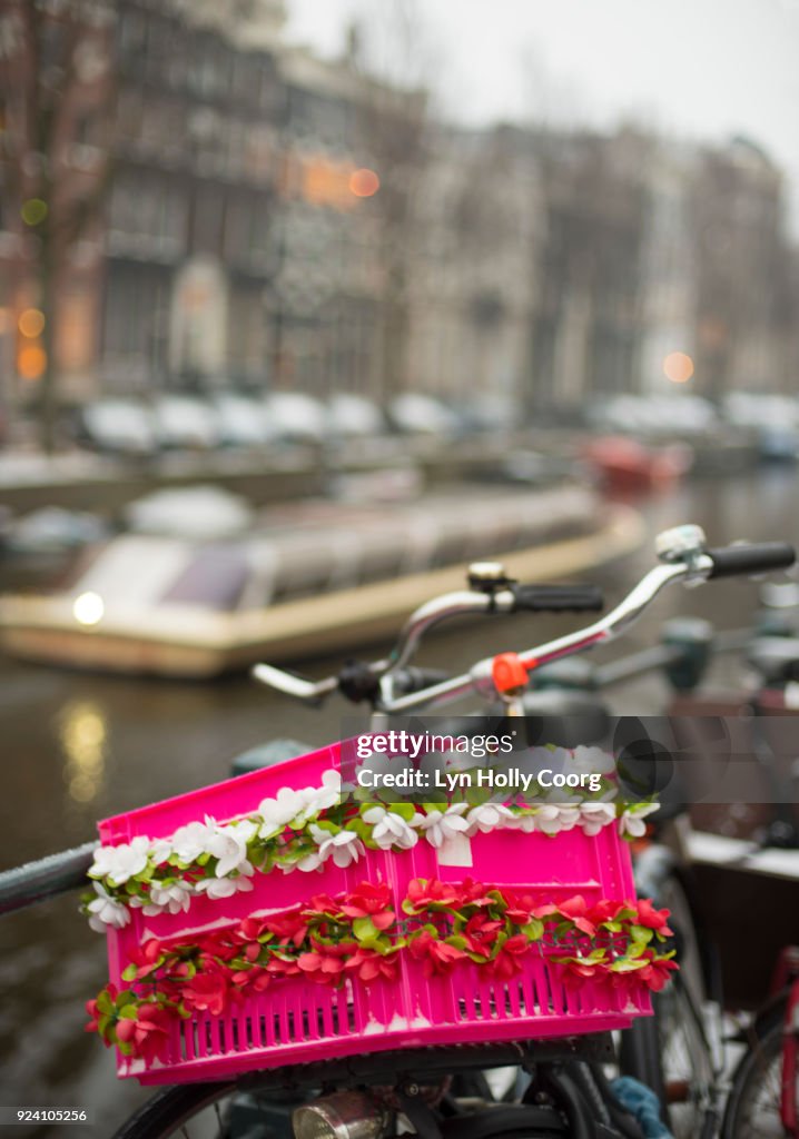 Bicycle and pink basket in winter in Amsterdam