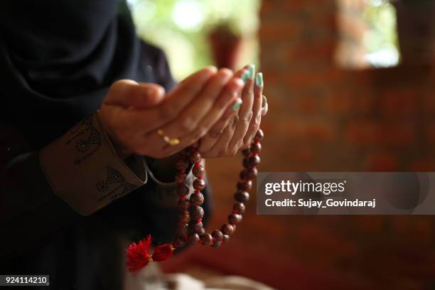 muslim woman praying - muslim praying stock pictures, royalty-free photos & images