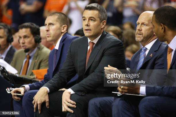Head coach Tony Bennett sits on the bench between associate athletic director Ronnie Wideman and assistant coach Brad Soderberg in the first half...