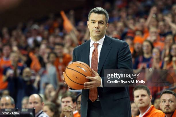 Head coach Tony Bennett of the Virginia Cavaliers holds a basketball in the first half during a game against the Georgia Tech Yellow Jackets at John...