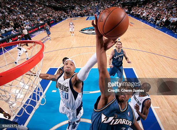 Caron Butler of the Washington Wizards goes up for the rebound against Drew Gooden of the Dallas Mavericks during the season opener at the American...