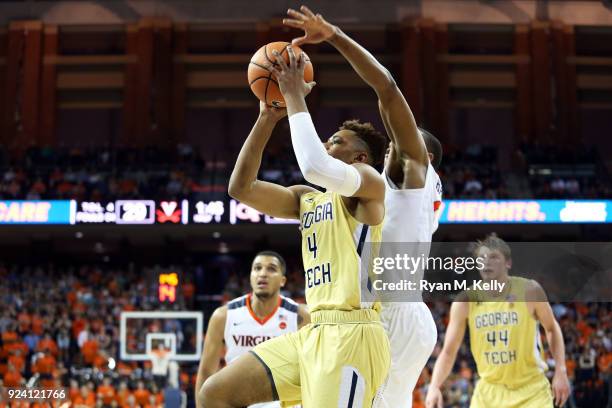 Brandon Alston of the Georgia Tech Yellow Jackets shoots in front of Devon Hall of the Virginia Cavaliers in the first half during a game at John...