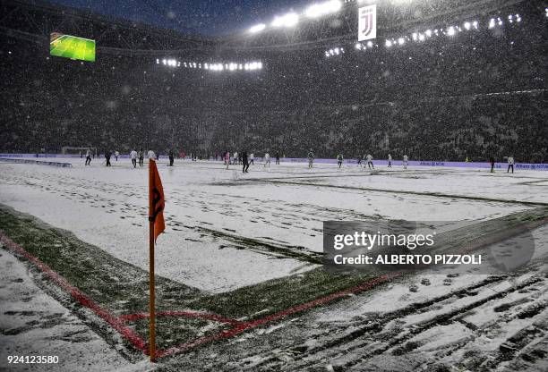 This photo taken on February 25, 2018 shows snow covering the pitch prior to the postponing of the Italian Serie A football match Juventus versus...