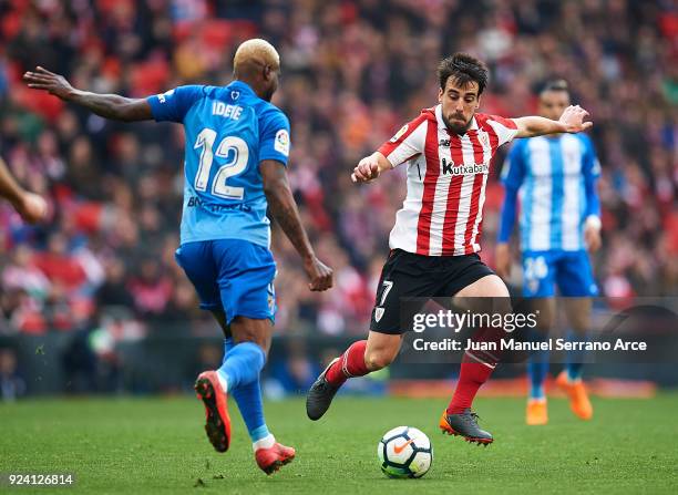 Brown Aide Ideye of Malaga CF competes for the ball with Benat Etxebarria of Athletic Club during the La Liga match between Athletic Club Bilbao and...