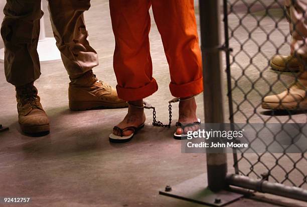 Non-compliant" detainee is escorted by guards after showering inside the U.S. Military prison for "enemy combatants" on October 27, 2009 in...