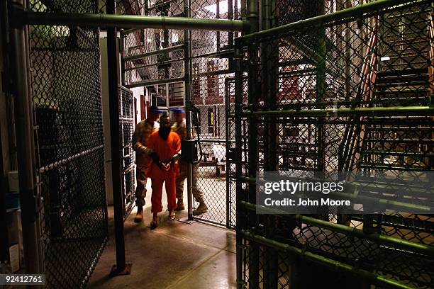 Non-compliant" detainee is escorted by guards after showering inside the U.S. Military prison for "enemy combatants" on October 27, 2009 in...
