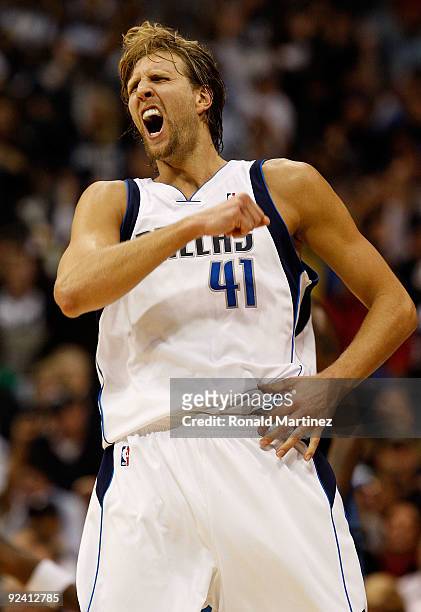 Forward Dirk Nowitzki of the Dallas Mavericks reacts after scoring a three-point shot against the Washington Wizards during the season opener on...
