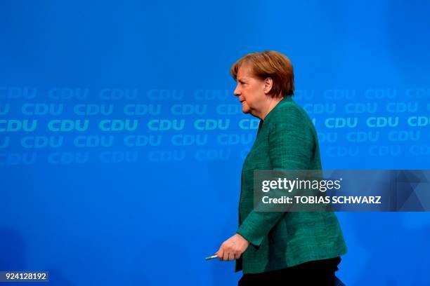 German Chancellor Angela Merkel, also leader of Germany's conservative Christian Democratic Union party, leaves after she gave a press conference...