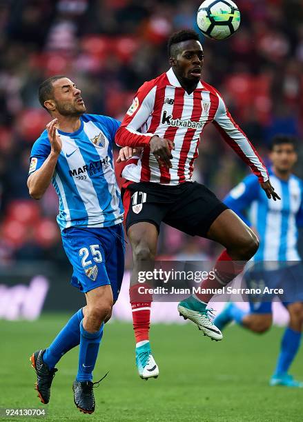 Medhi Lacen of Malaga CF competes for the ball with Inaki Williams of Athletic Club during the La Liga match between Athletic Club Bilbao and Malaga...