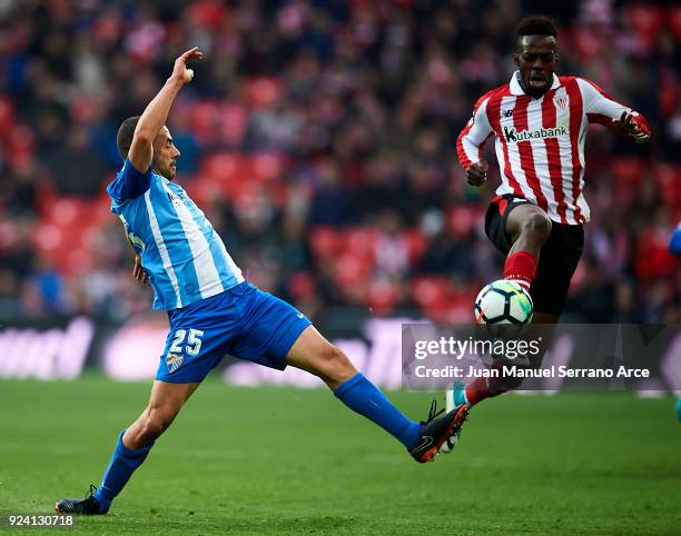 Medhi Lacen of Malaga CF competes for the ball with Inaki Williams of Athletic Club during the La Liga match between Athletic Club Bilbao and Malaga...