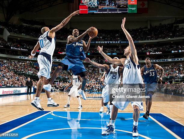 Gilbert Arenas of the Washington Wizards goes in for the layup against Shawn Marion and Dirk Nowitzki of the Dallas Mavericks during the season...