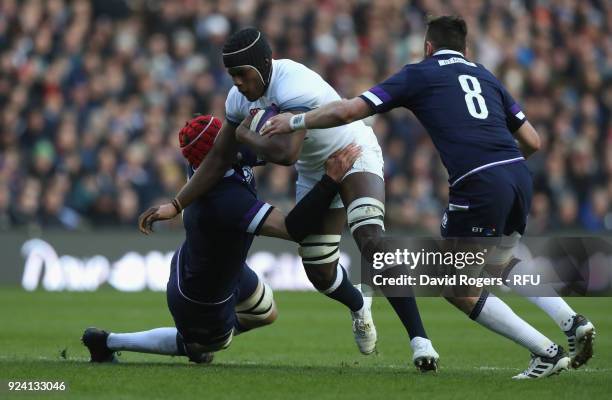 Maro Itoje of England is tackled by Grant Gilchrist and Ryan Wilson during the NatWest Six Nations match between Scotland and England at Murrayfield...