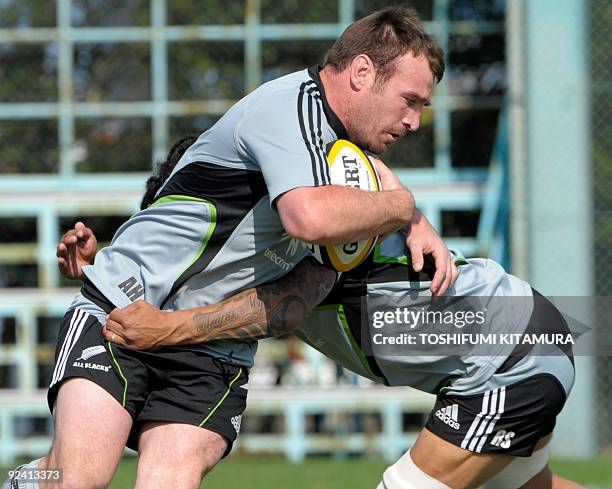 New Zealand All Blacks Andrew Hore is tackled by Rodney So'oialo during the team's training session in Funabashi, an eastern suburb of Tokyo on...